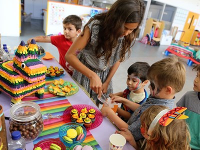 Children gathered around pinata cake